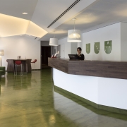 hotel reception desk in walnut wood and solid surface