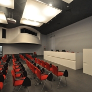 white conference desks and red chairs