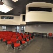 curving mezzanine and red chairs