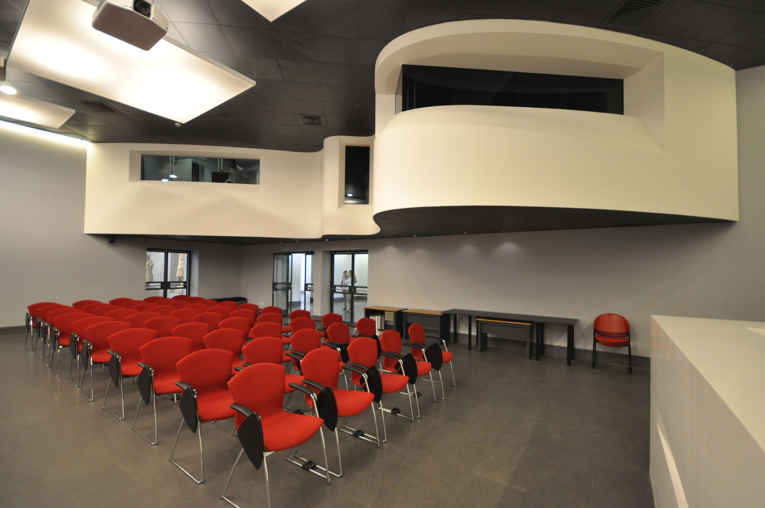 curving mezzanine and red chairs