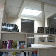 exhibition wall in wood with books