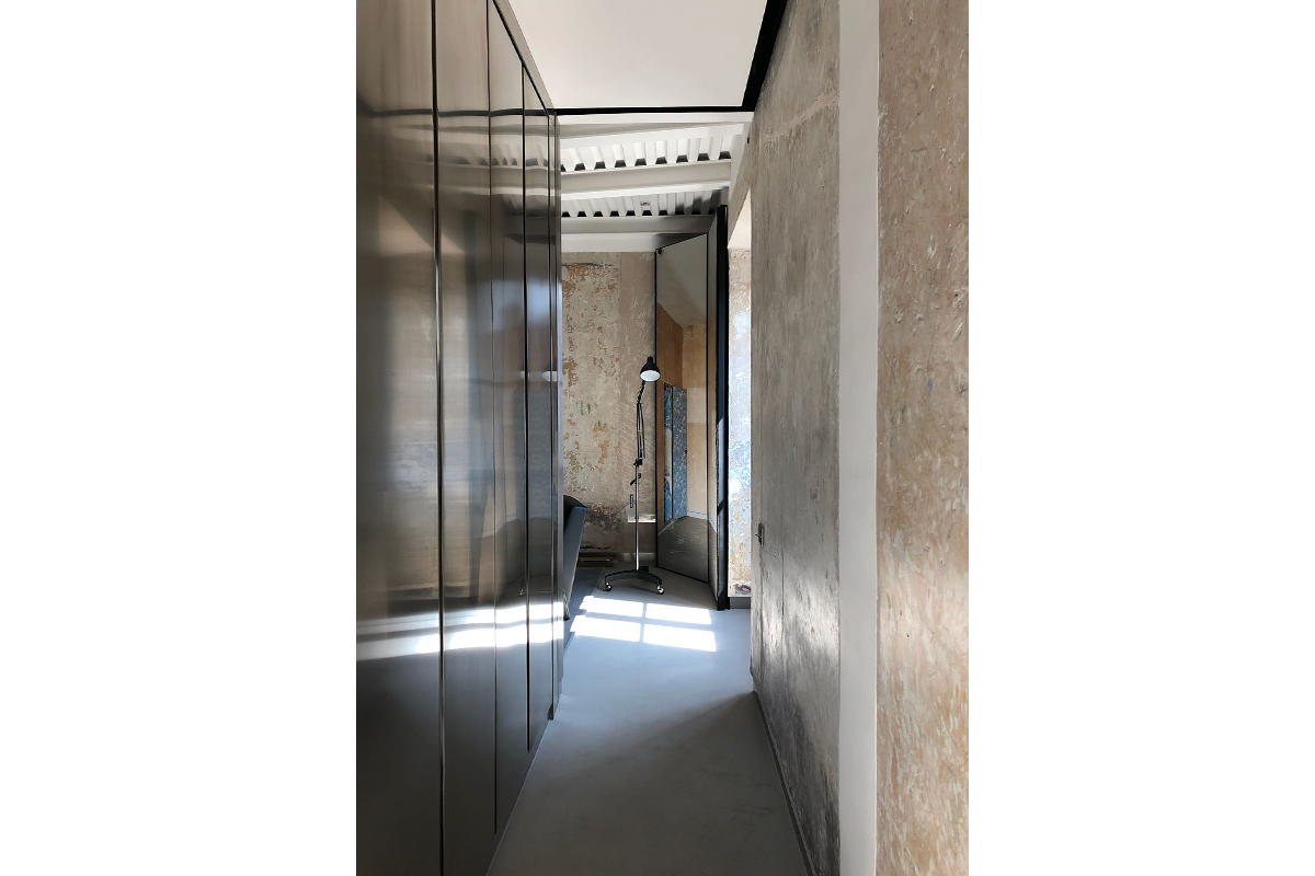 Palazzo Rhinoceros corridor with bespoke stainless steel cabinets and furniture by Jean Nouvel Design