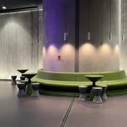 curving green bench, tables and stools